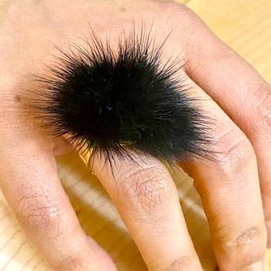 Gold coloured with black Pom ring